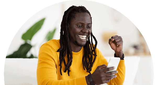 image of a man looking at his phone with his hand in the air after successfully securing the flexible loan period he was seeking